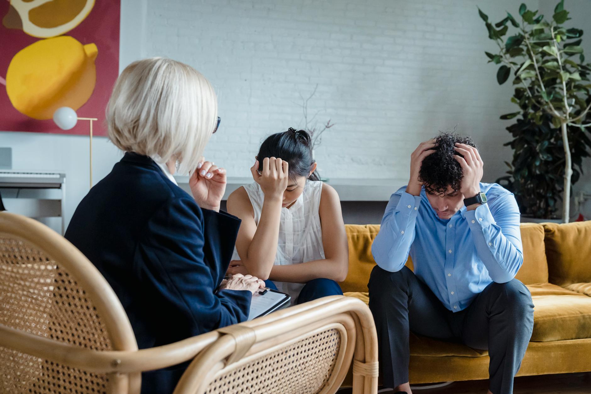 Stressed couple in therapy with a psychologist, discussing relationship issues. - reddit marriage advice