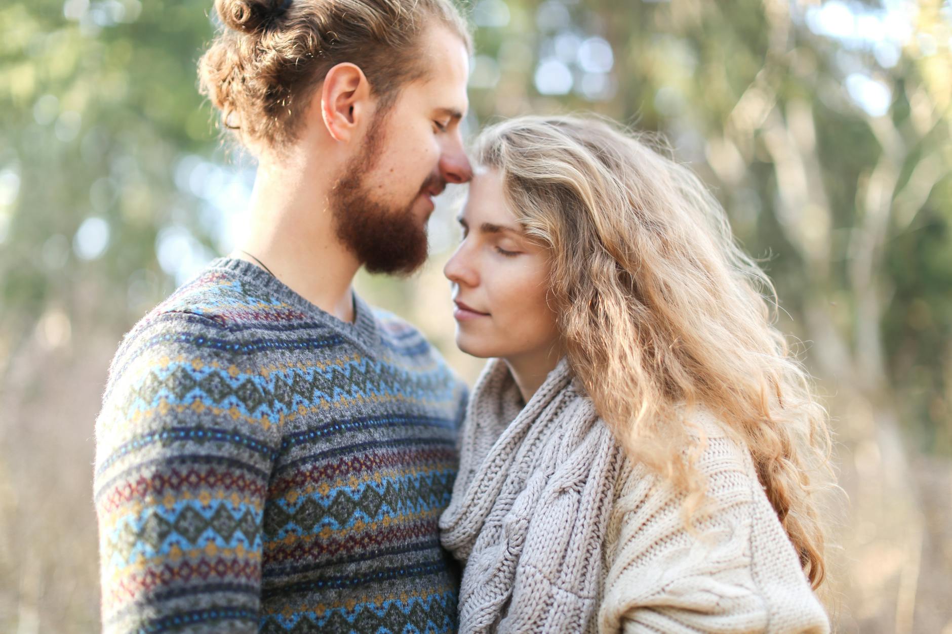 A warm and intimate moment between a couple in a serene outdoor setting, showcasing love and affection. - rekindle intimacy long term relationships