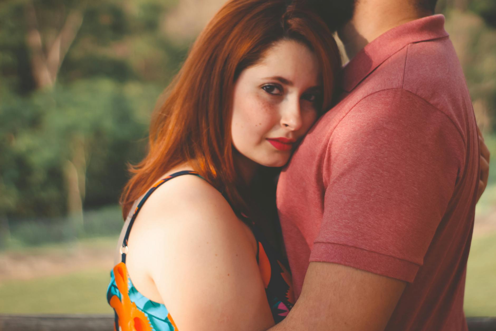 Close-up of a couple embracing in a sunny outdoor setting, showcasing love and intimacy. - rekindle intimacy in relationship