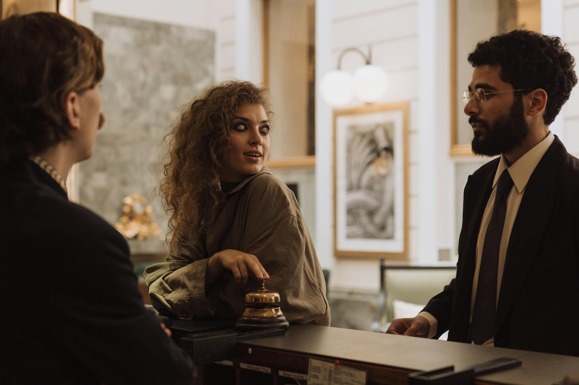 Guests interacting at a luxurious hotel reception desk, emphasizing hospitality and service. - relationship communication check-in
