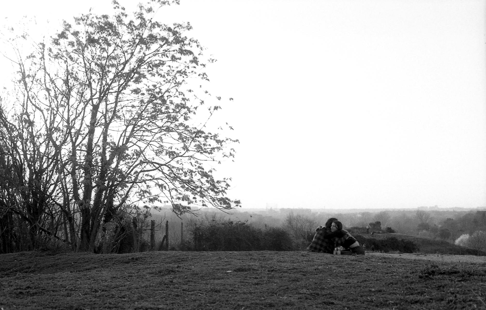 Couple embracing in a serene black and white countryside setting, capturing romance and nature. - how to show platonic love