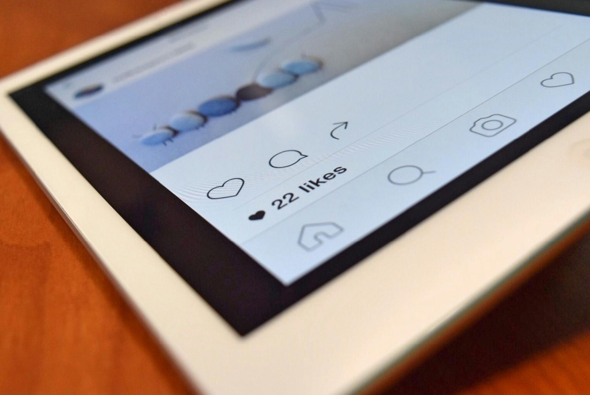 Photo of a tablet displaying a social media app interface with 22 likes, highlighting digital interaction. - social media mental health