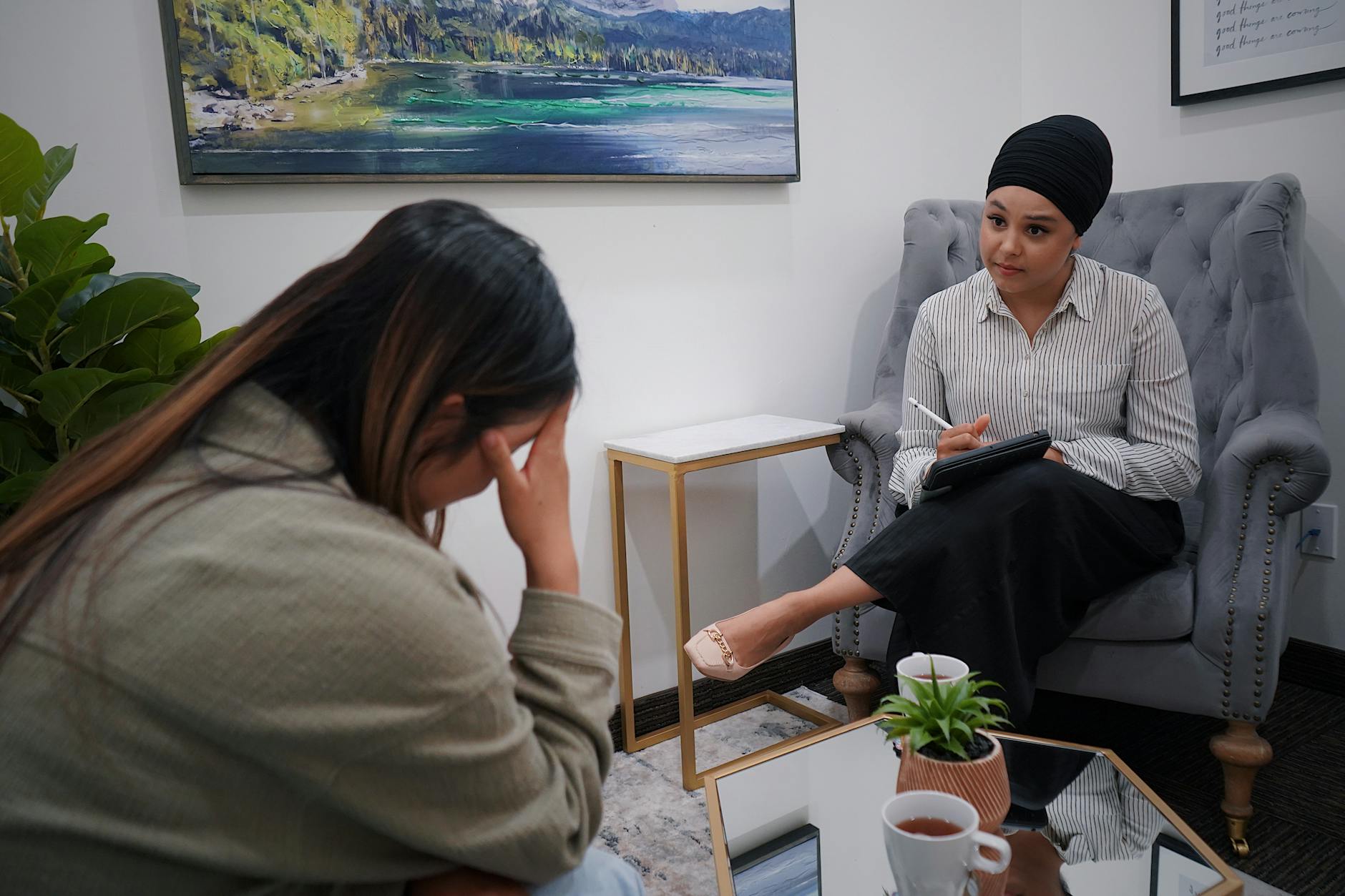 A woman discusses personal issues in a therapy session with a professional counselor. - spring anxiety help
