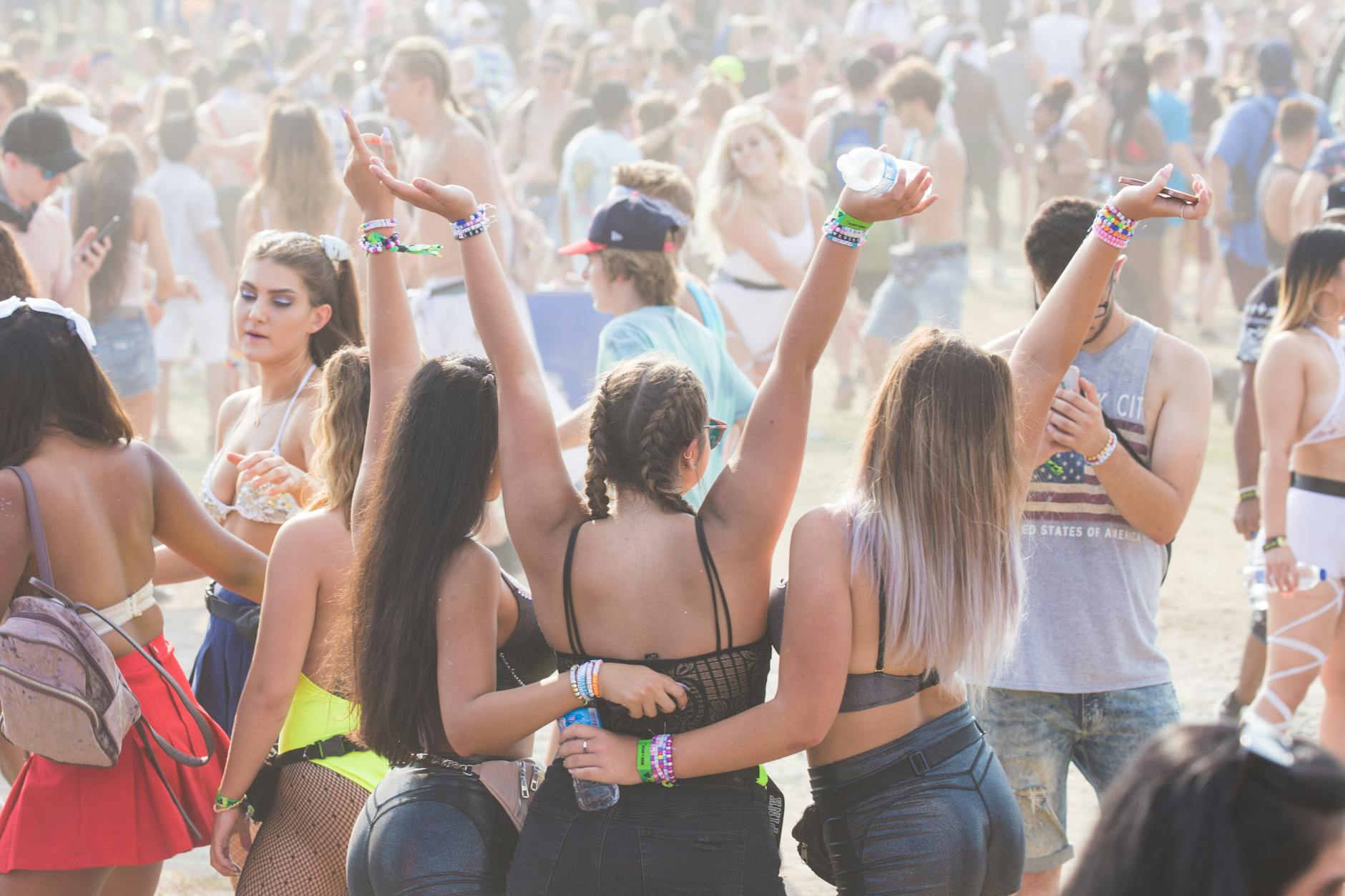 Energetic crowd enjoying an outdoor festival with music and dancing. Perfect for lifestyle and event themes. - spring break activities