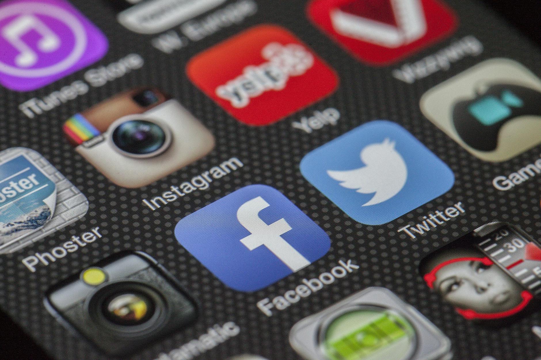 Close-up image of various social media app icons on a smartphone screen. - spring dating app