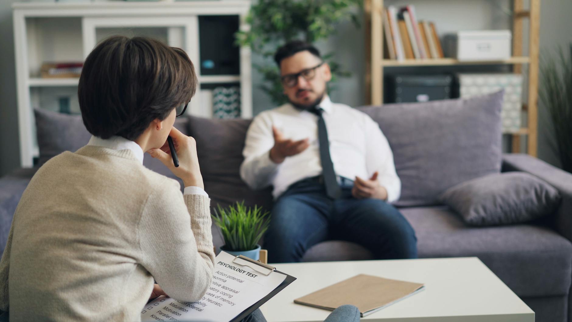 Therapist and client discussing problems in a modern office environment. - spring depression help