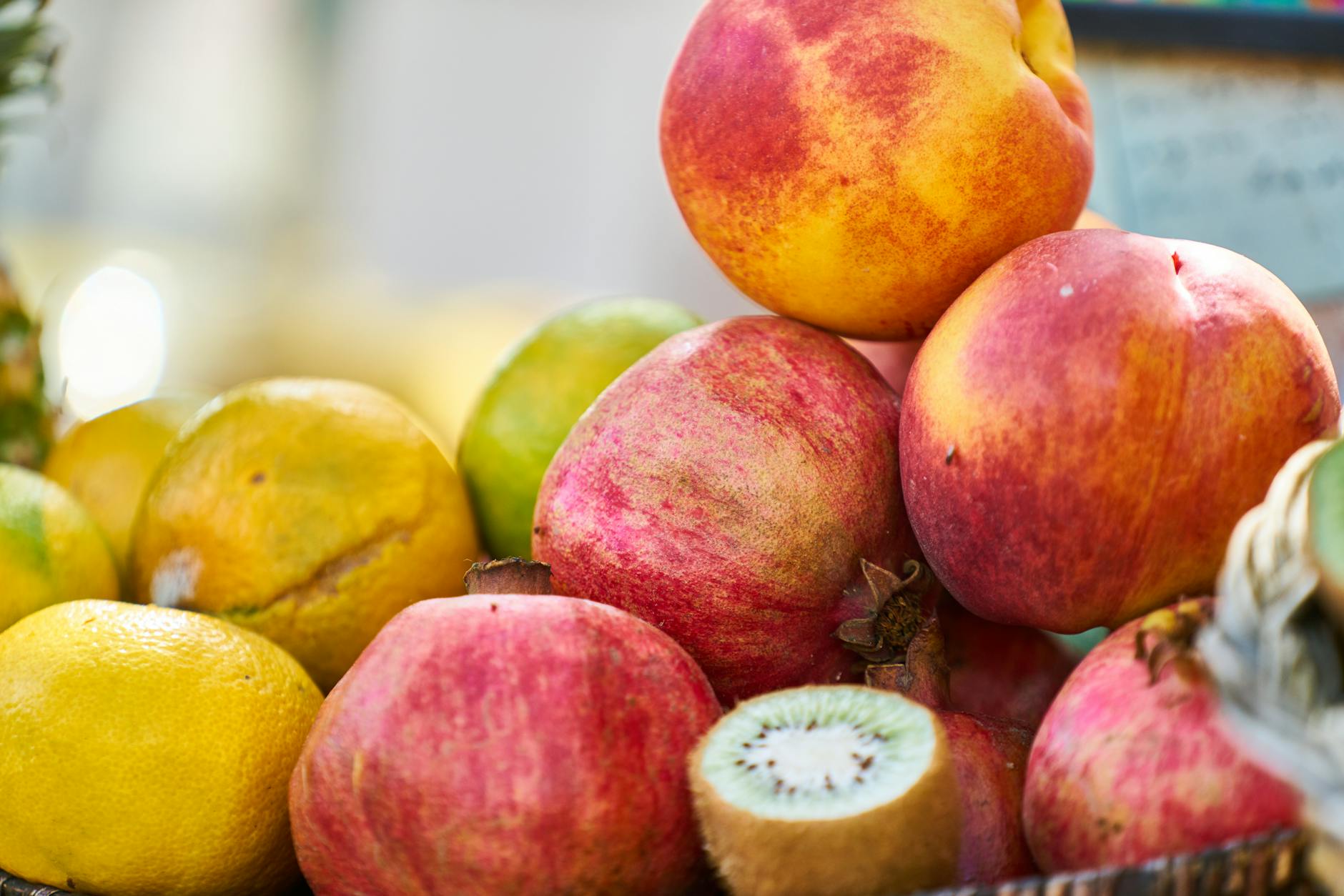 Vibrant assortment of fresh fruits including citrus, kiwi, and pomegranate, showcasing healthy, colorful produce. - spring energy boost