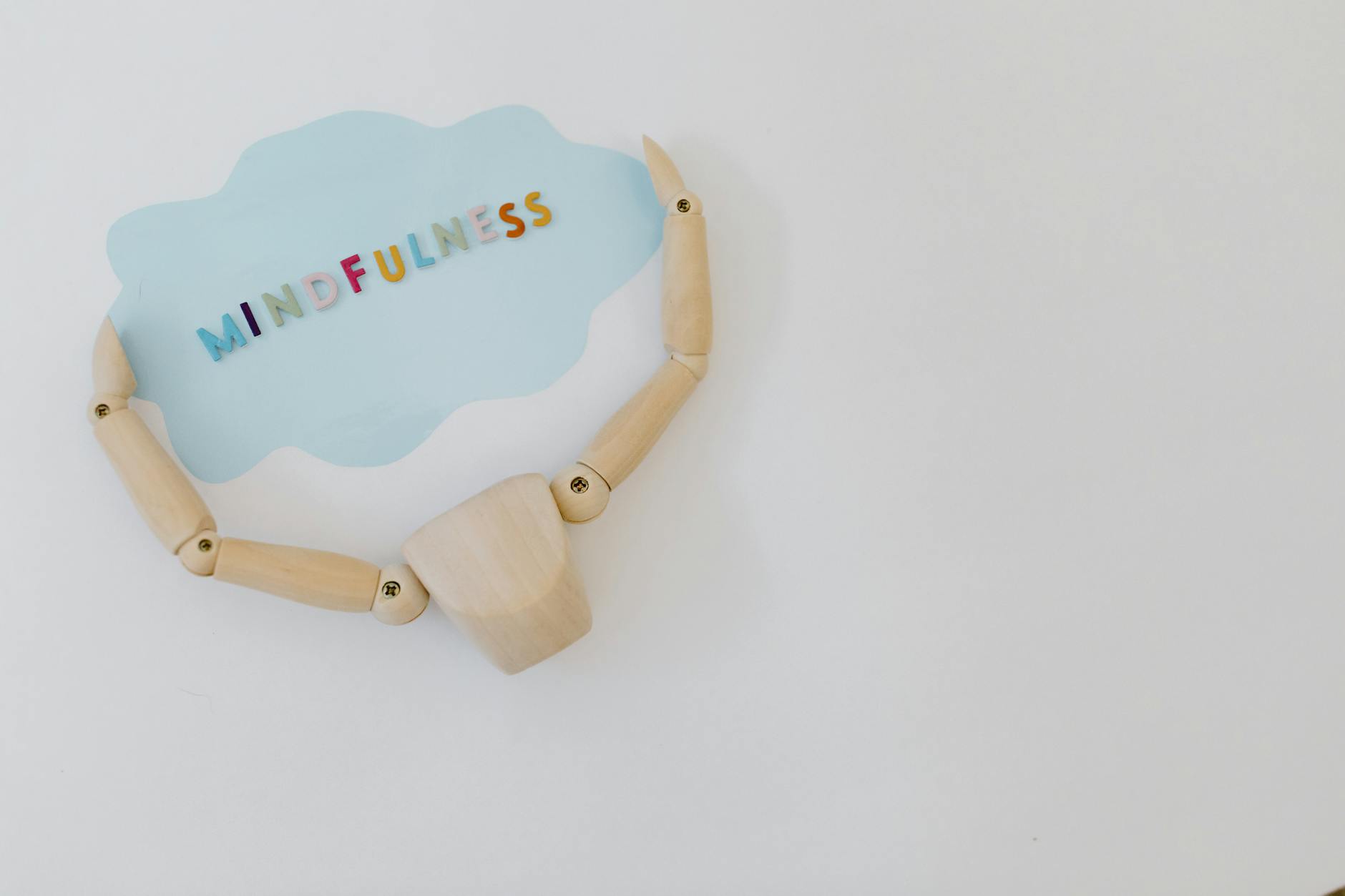 Wooden mannequin holding a mindfulness speech bubble for relaxation and mental health concepts. - spring mental clarity