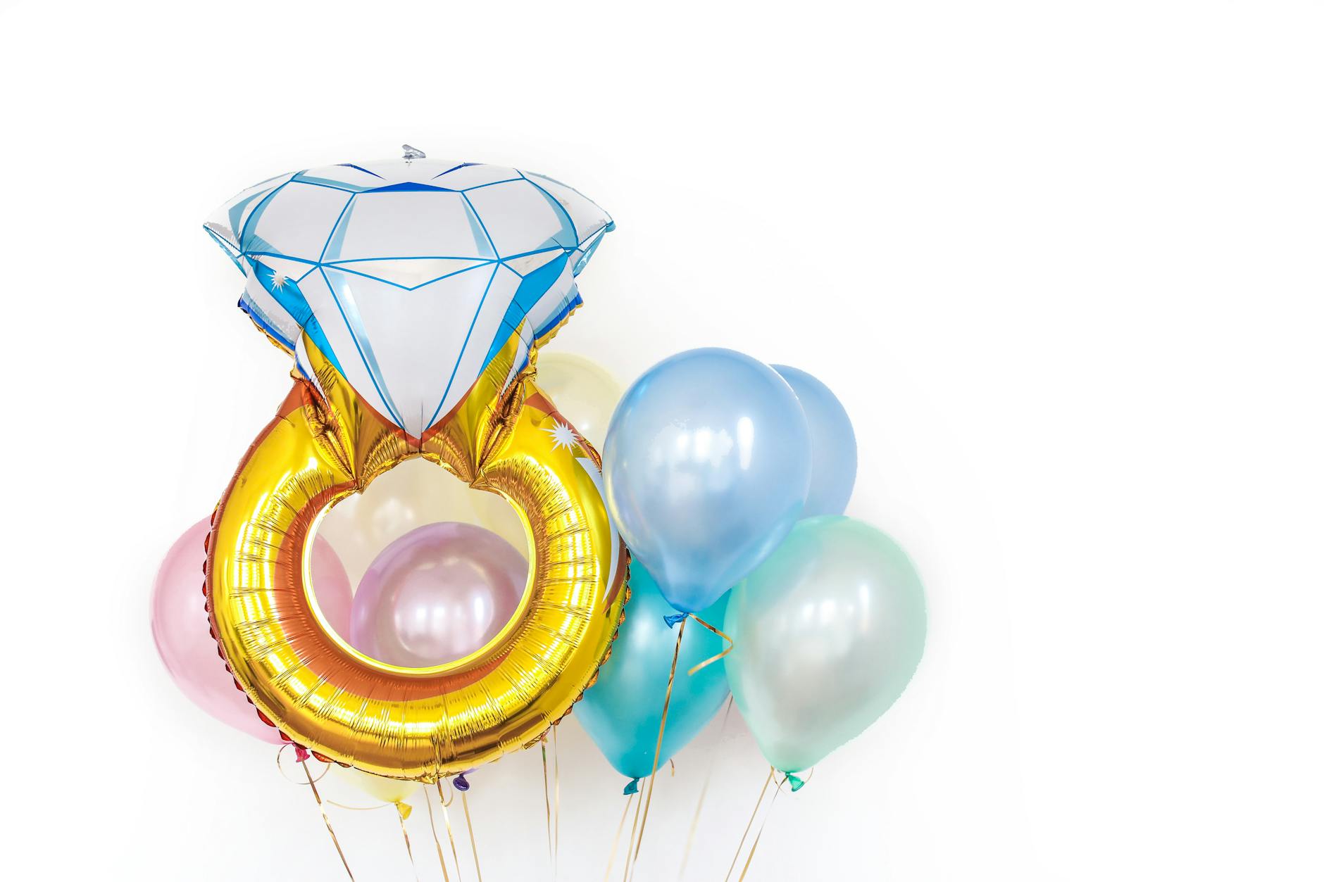 Floating foil balloons featuring a diamond ring theme on a white background, perfect for celebrations. - spring outdoor date ideas