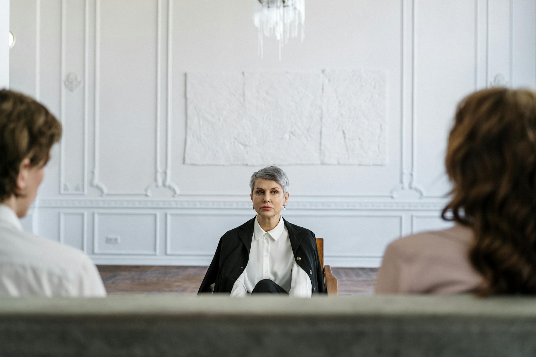 A married couple in a consulting session with a therapist in a modern, minimalistic office. - spring relationship advice