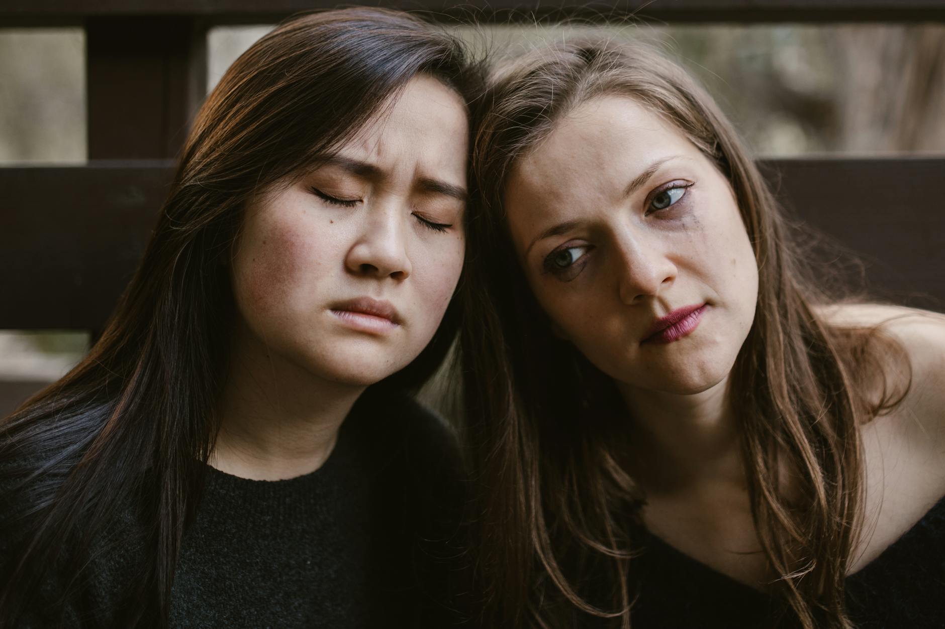 Two women in a soothing embrace, expressing empathy and friendship. - spring sadness relief
