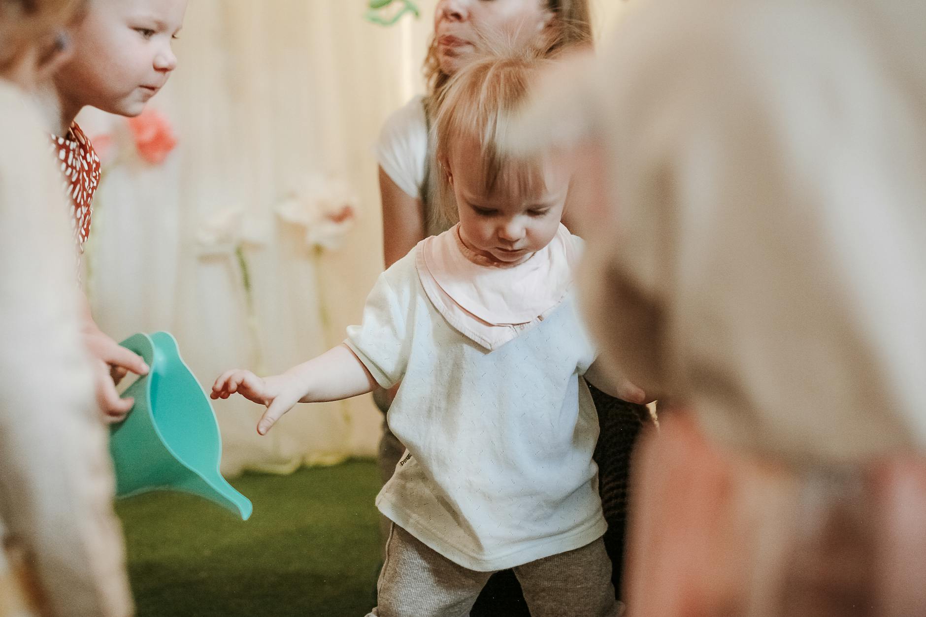 Young children playing and exploring in an indoor preschool environment. - toddler playdate skills