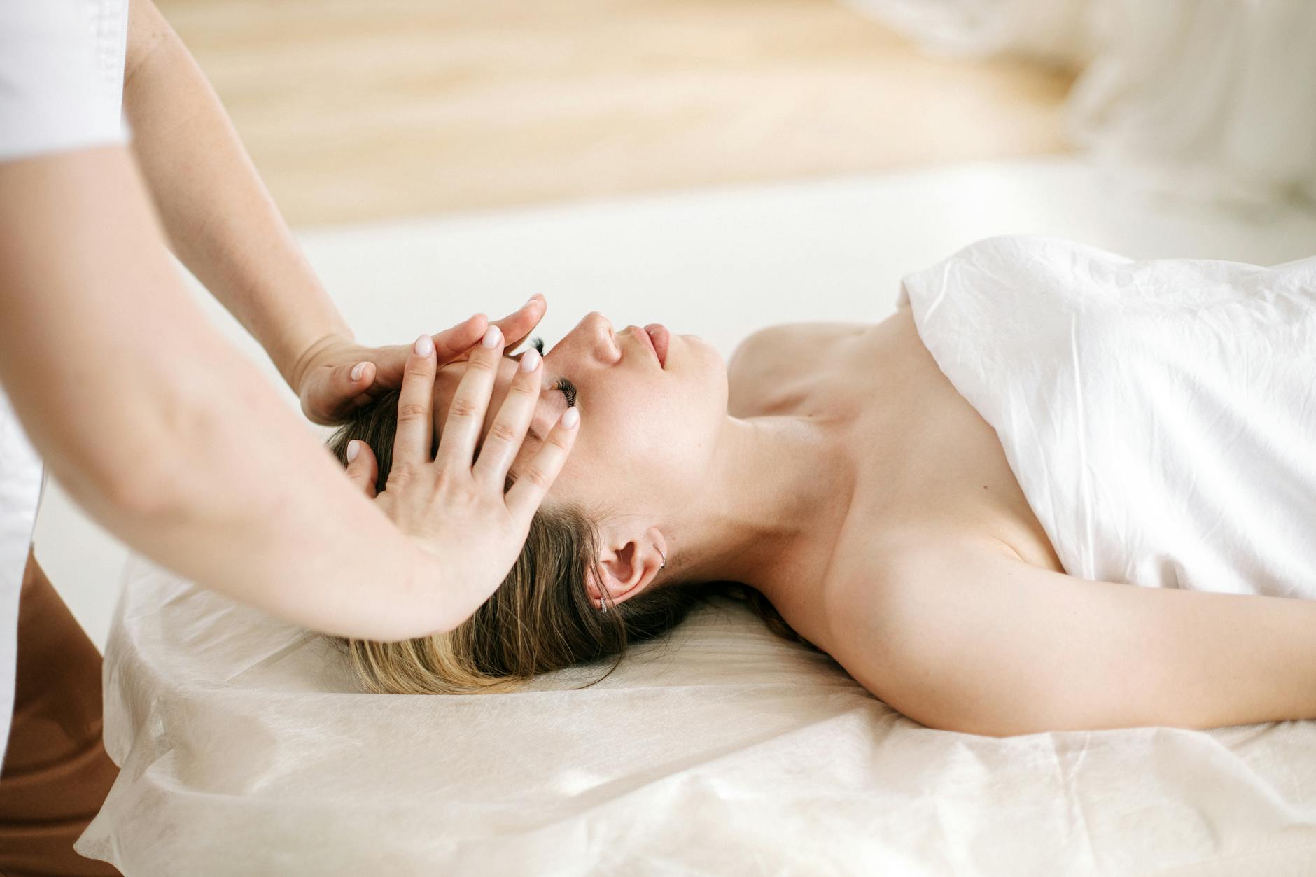 Woman receiving a soothing facial massage at a luxurious spa, enhancing relaxation and wellness. - winter sluggishness treatment