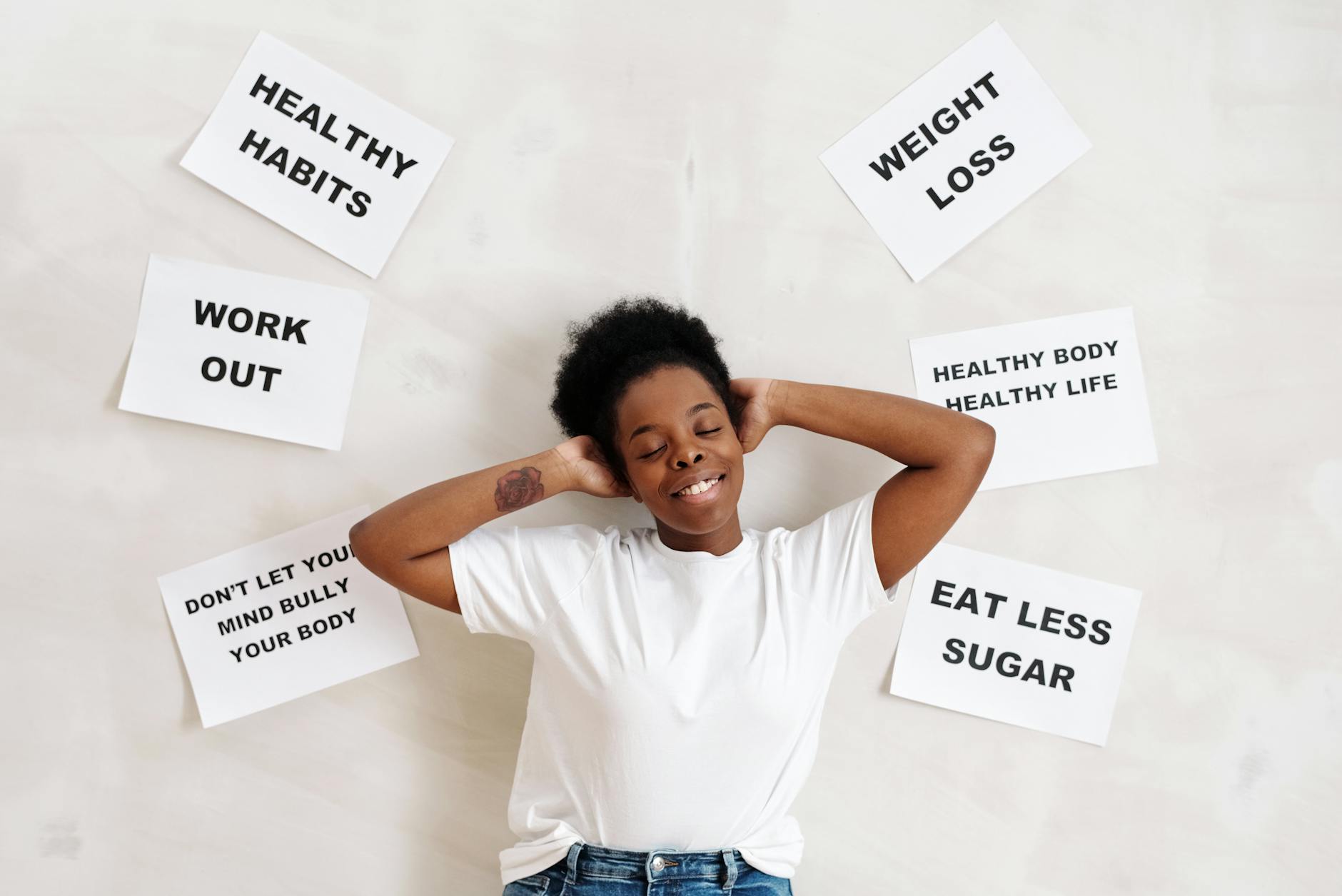 Smiling woman embracing positive lifestyle with healthy living messages around her. - boost mood naturally
