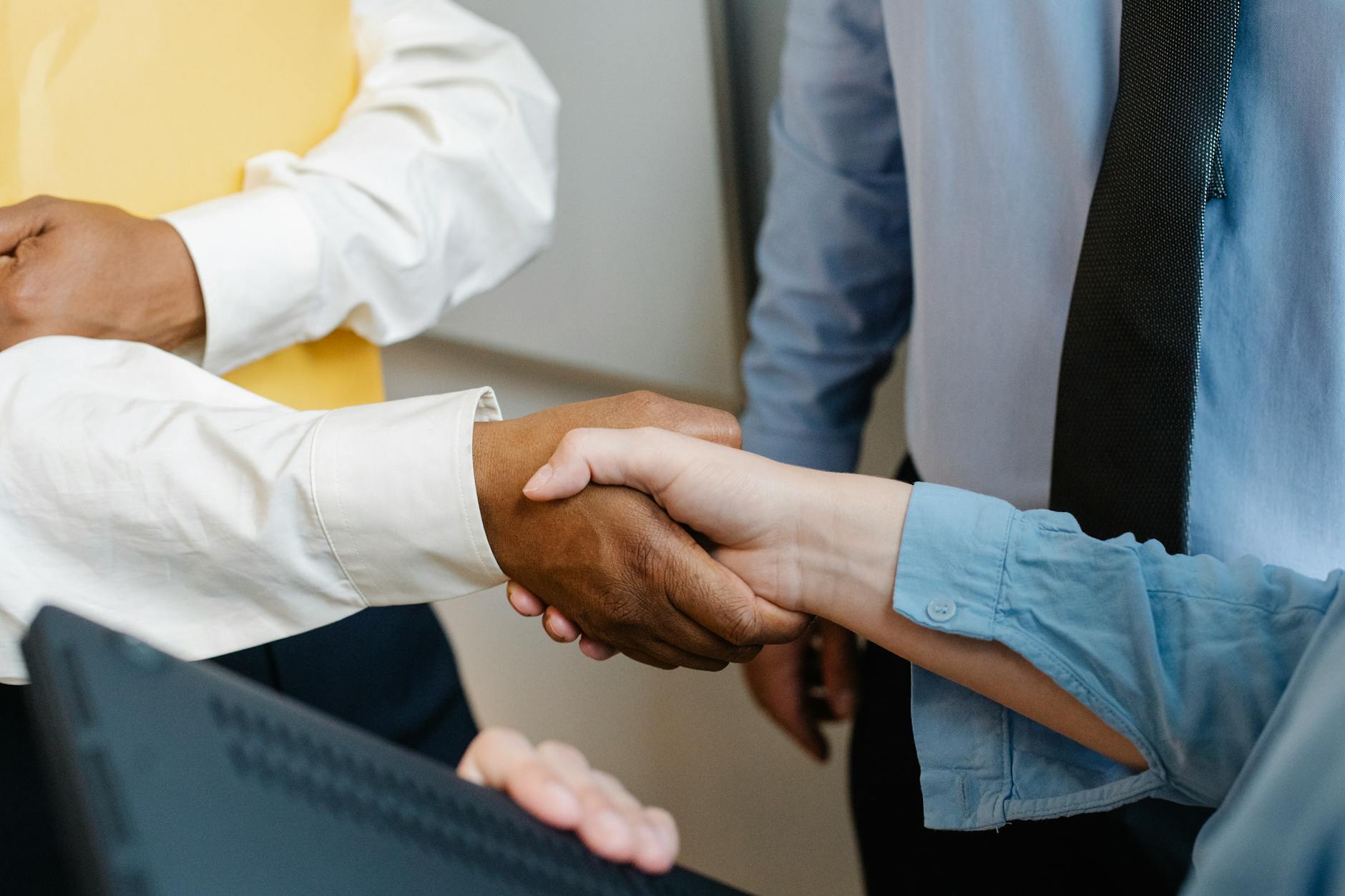 Crop anonymous diverse entrepreneurs shaking hands after meeting and negotiating about new project - build trust partner