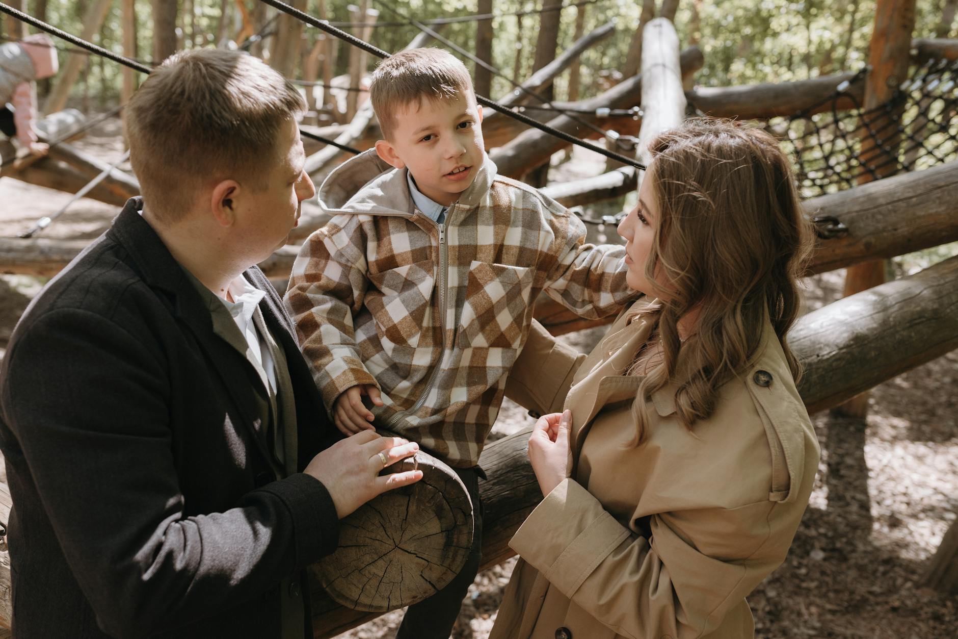 Family enjoying time at an outdoor park, engaging and playful. - co-parenting after divorce
