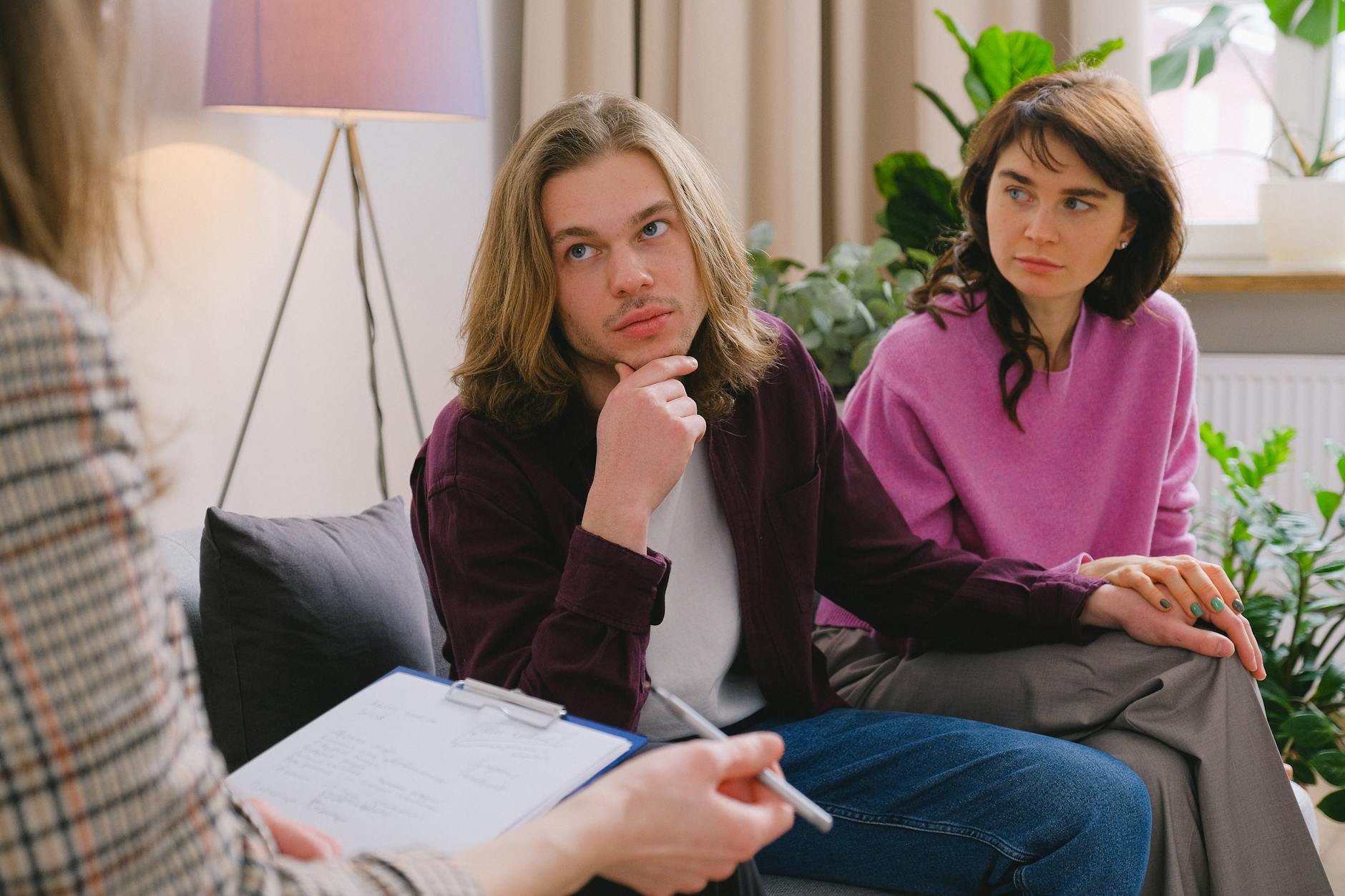 A couple holding hands during a therapy session in an office setting. - couples therapy fresh start