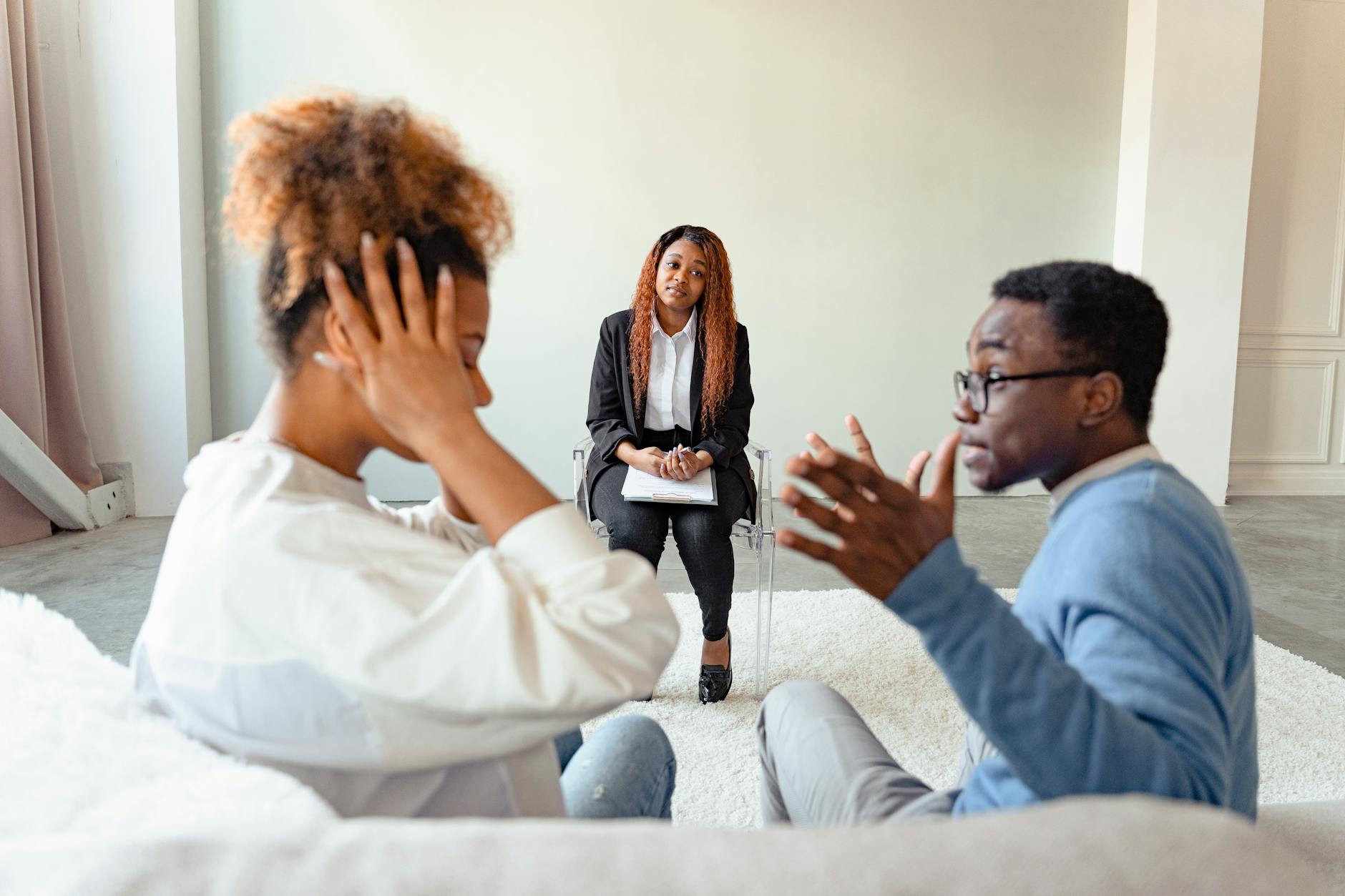 A couple in therapy session with a mental health professional indoors. - couples therapy fresh start