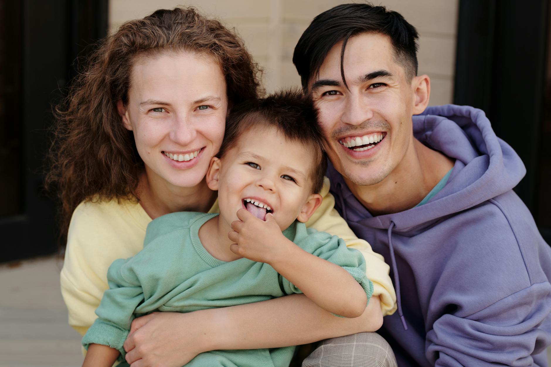 Cheerful family enjoying quality time together with bright smiles and warm embrace. - express needs family