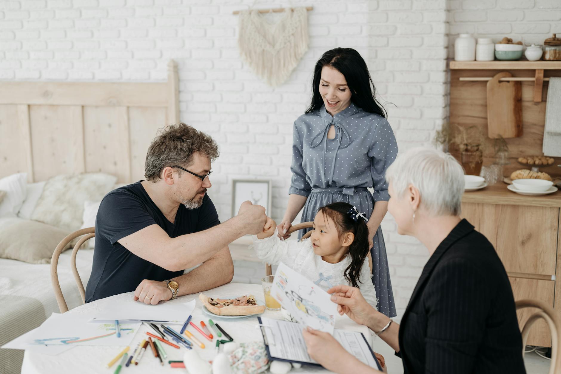 Child with foster parents and a social worker discussing adoption at home. - family communication skills