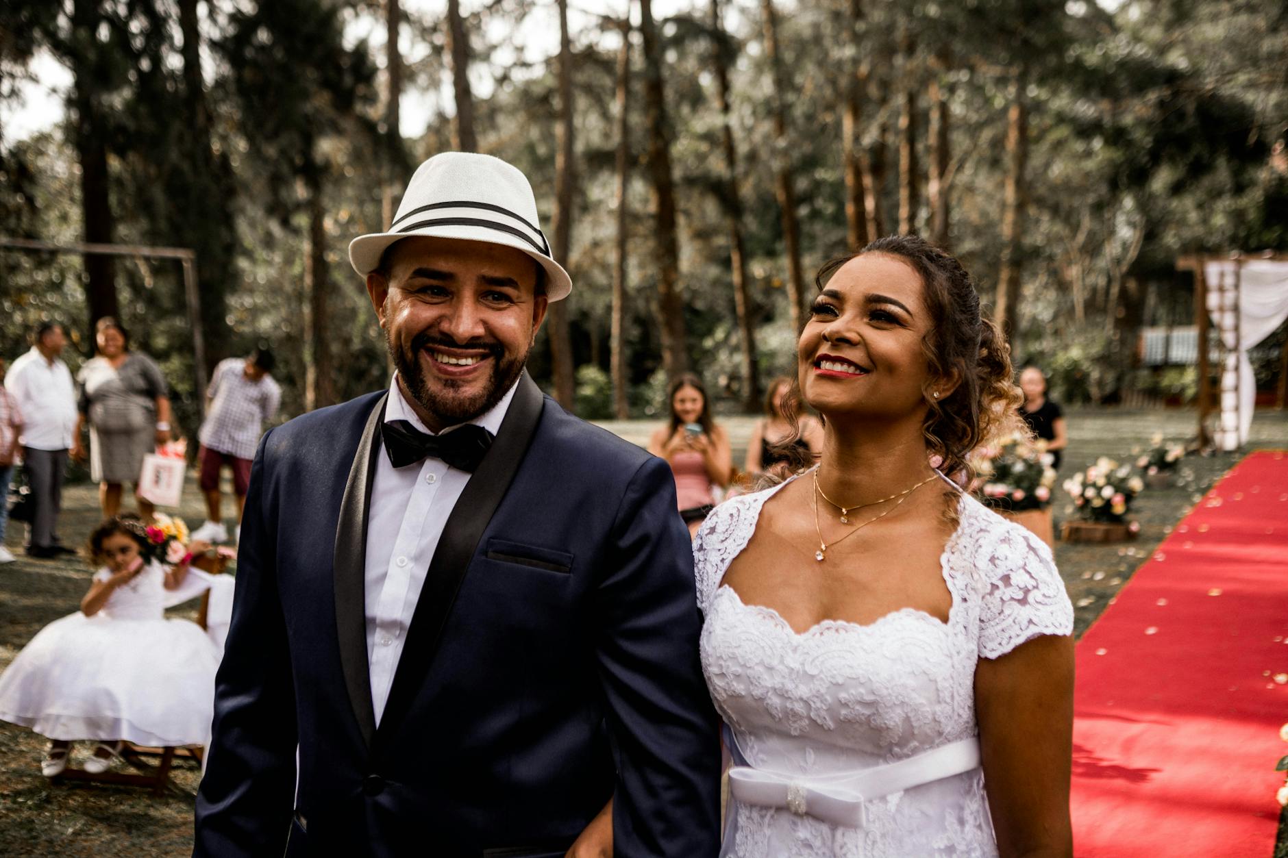 A happy bride and groom walking down the aisle outdoors during their wedding ceremony. - marriage joy rediscovery