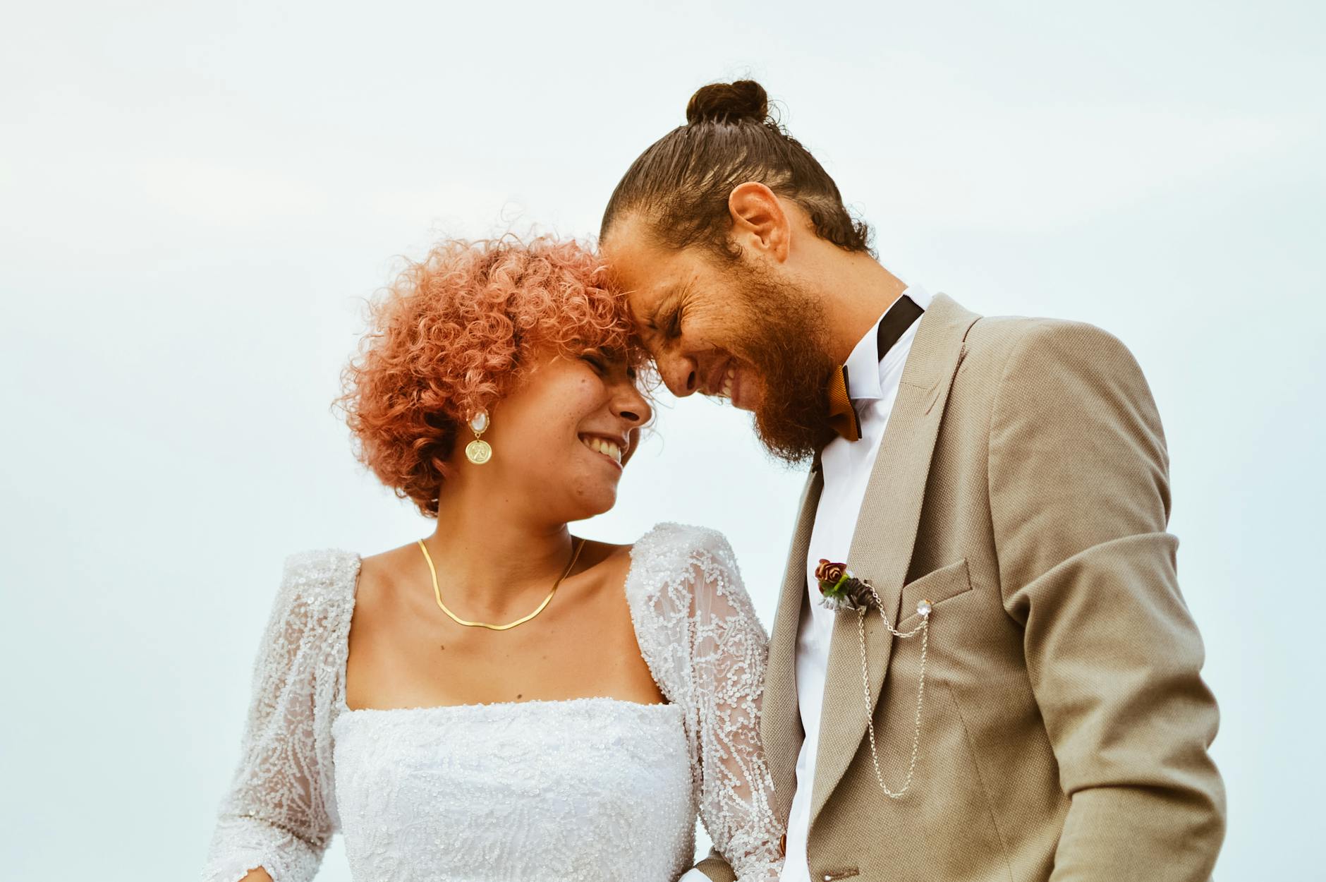 A joyful couple sharing a loving moment on their wedding day outdoors. - marriage joy rediscovery