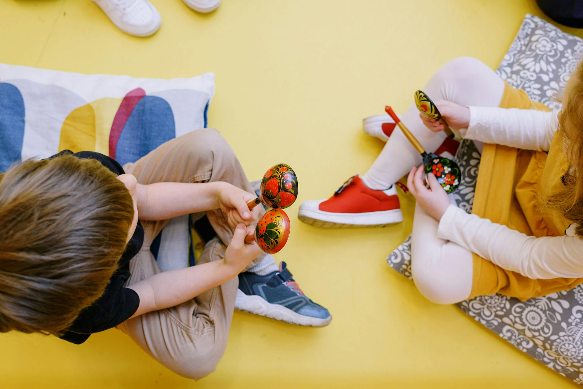 Joyful children playing maracas in a colorful preschool setting. - preschool spring schedule