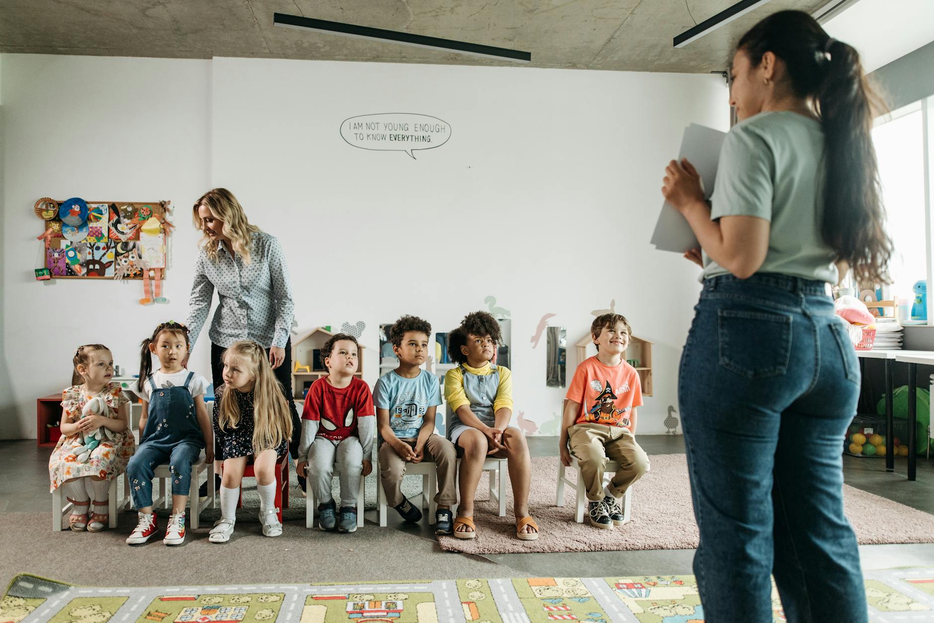 Diverse group of preschool children and teachers in an engaging classroom setting. - preschooler spring play