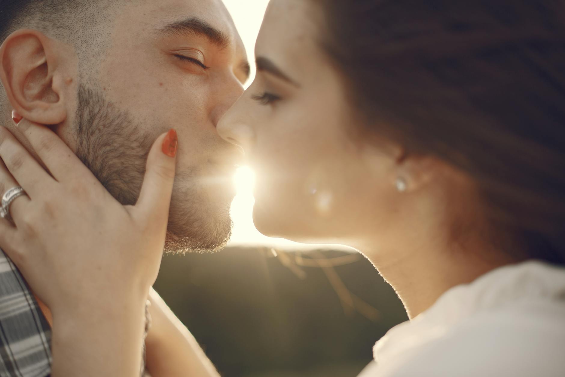 A loving couple shares a tender kiss in the warm glow of sunset. - rebuild marriage intimacy