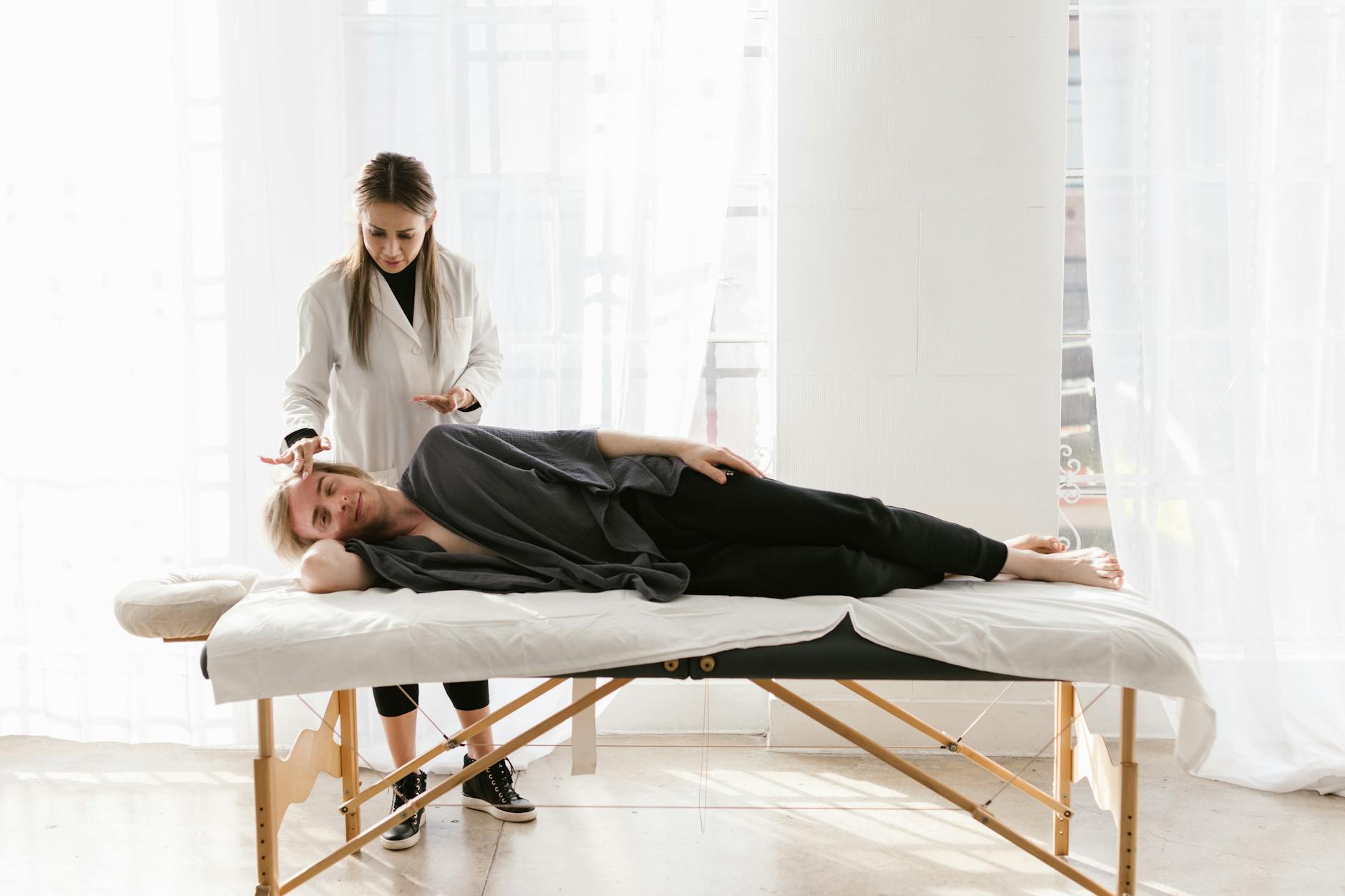 Young woman therapist provides relaxing massage therapy to a male client indoors. - therapist for spring change