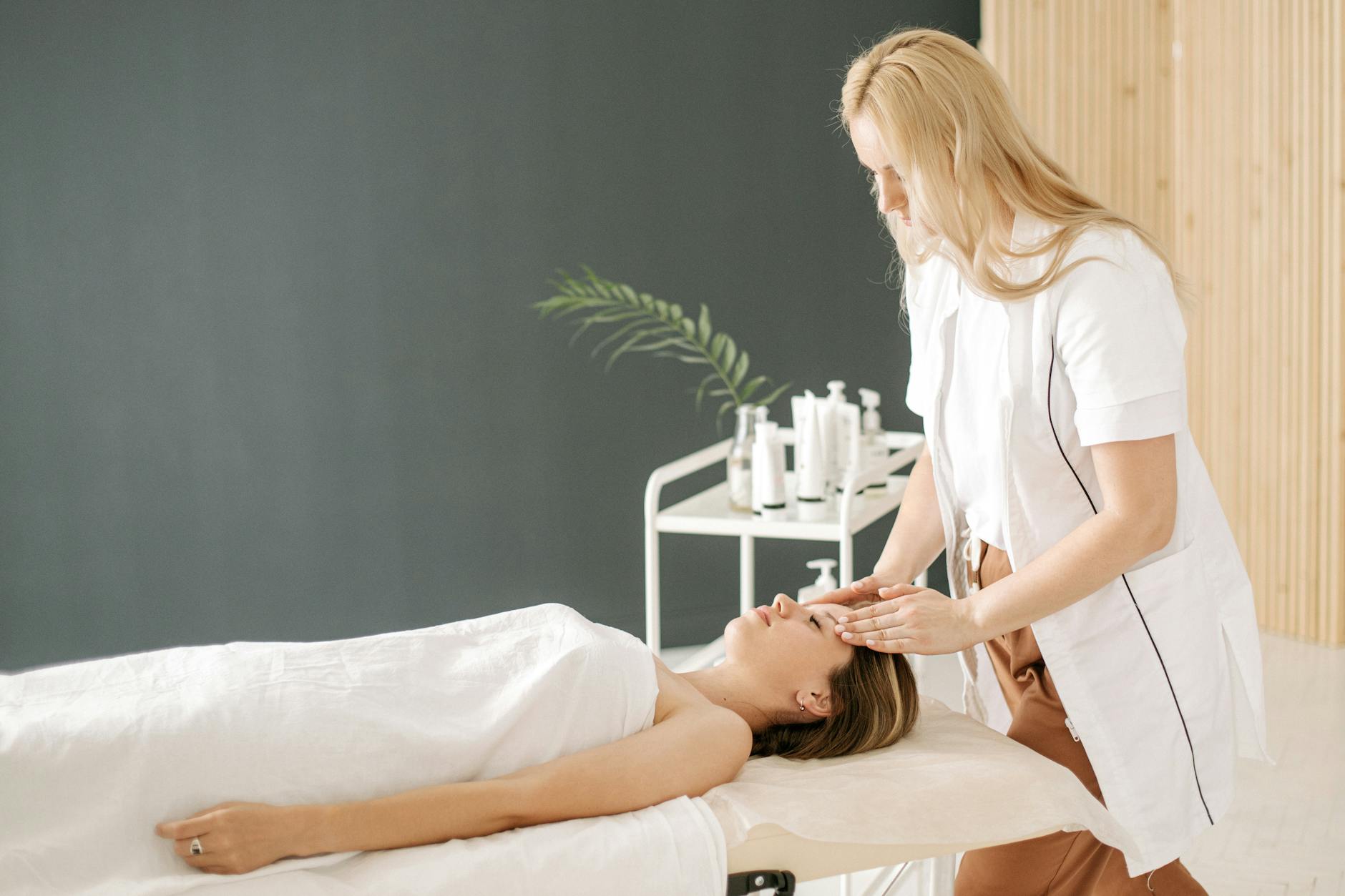 A woman receiving a relaxing face massage at a spa, promoting wellness and relaxation. - therapist for spring change