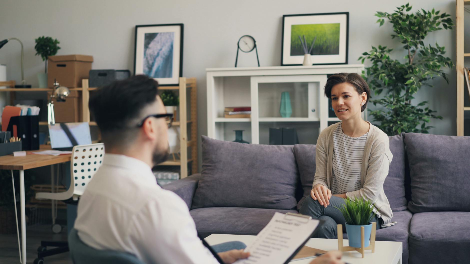 A therapist and client in a modern, relaxing office setting. - therapy tools growth
