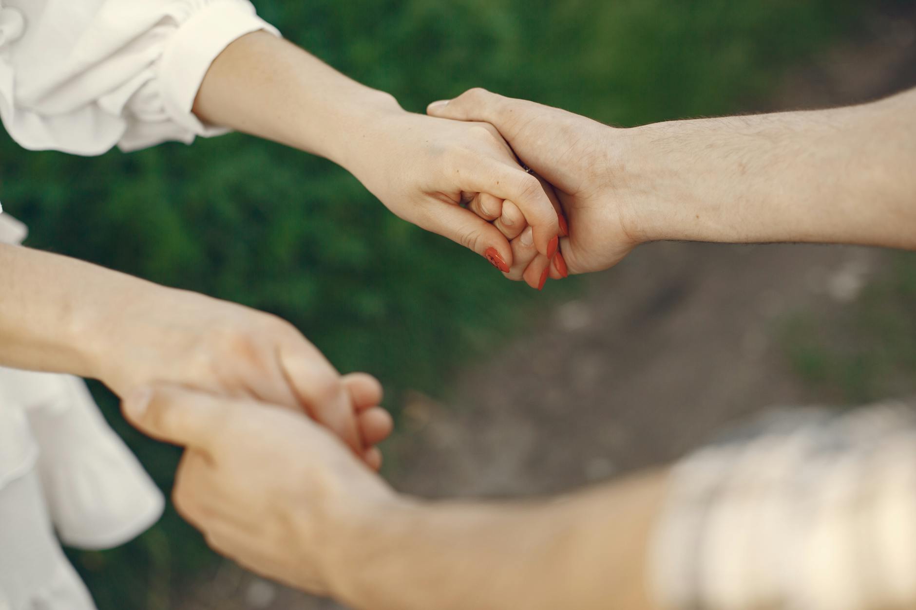 A couple holding hands in an outdoor setting symbolizing love and unity. - vulnerability in relationships
