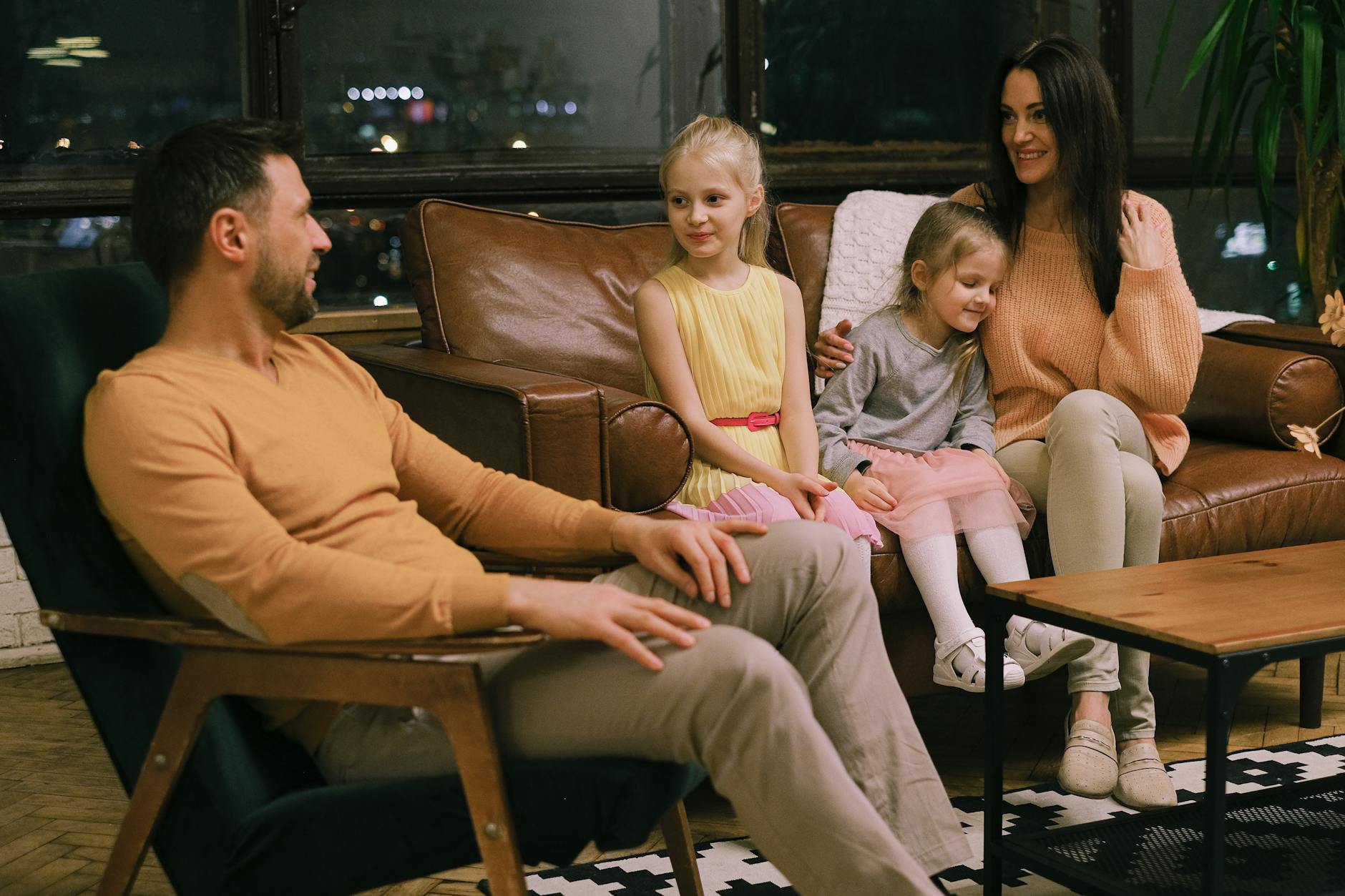 A family of four enjoying quality time together in a cozy indoor setting. - active listening family