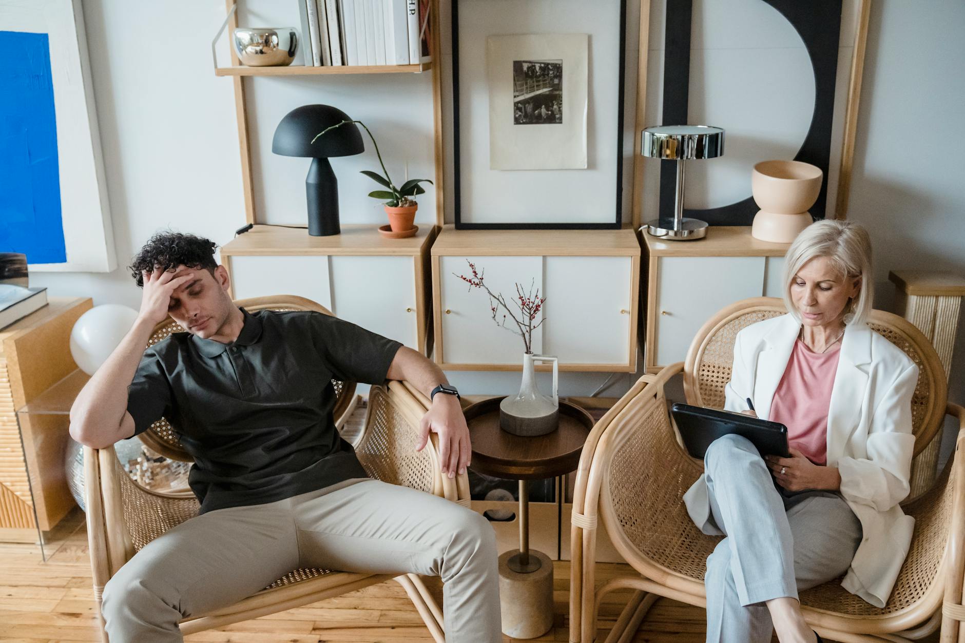 A stressed man and woman therapist in a modern consultation room. - attachment style therapist