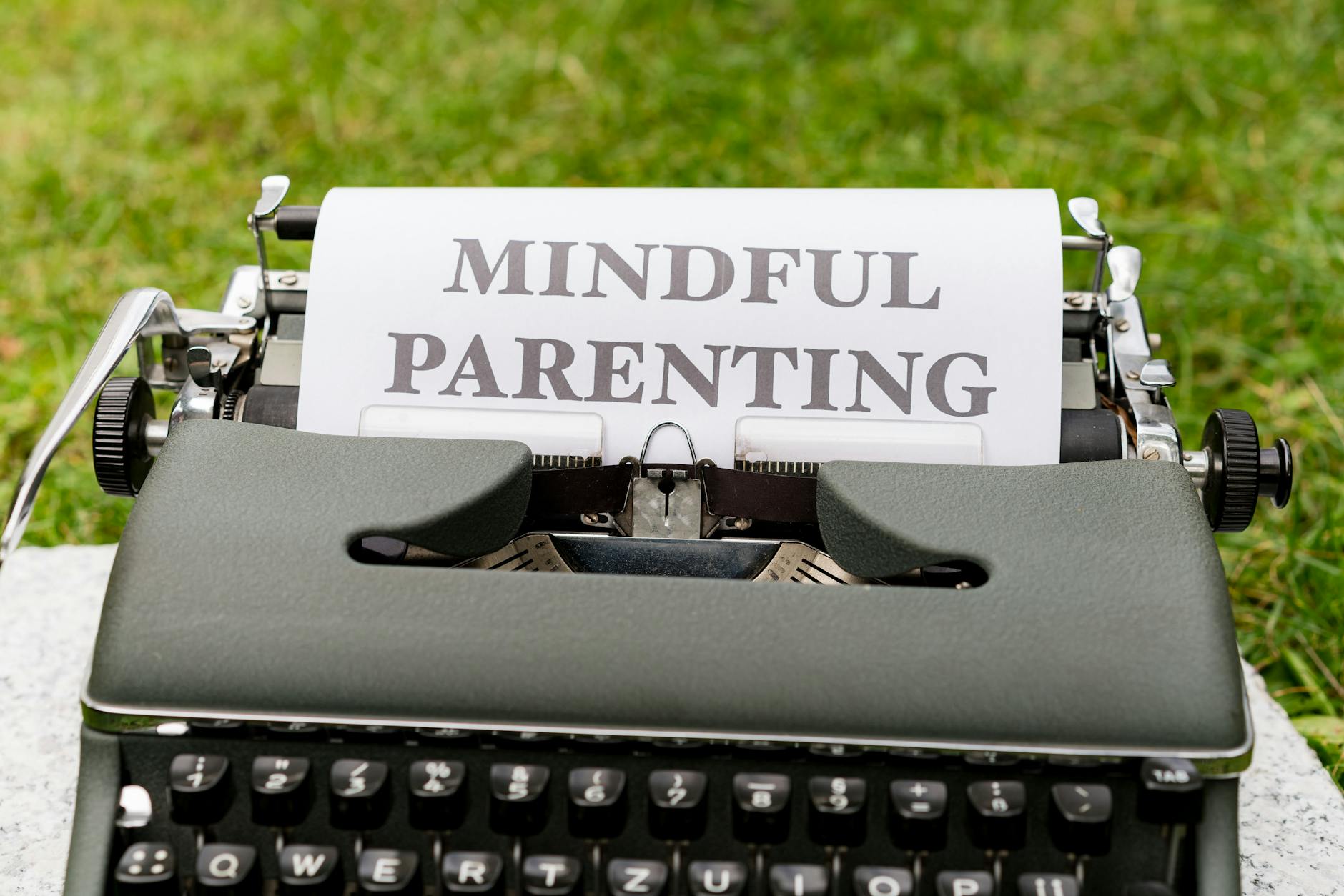 Close-up of a typewriter with 'Mindful Parenting' text, outdoors. - co-parenting after break