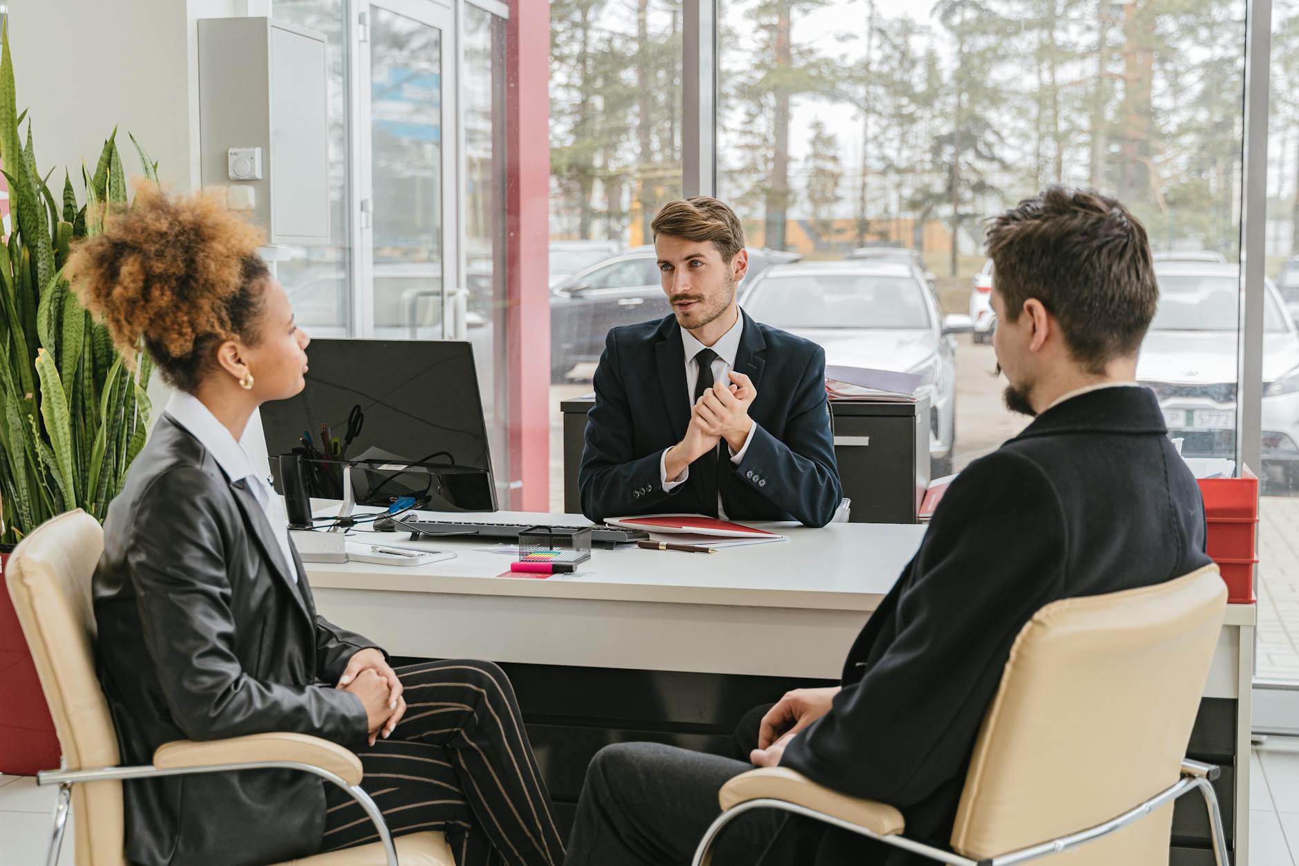 Professional meeting with clients at a modern office, discussing business solutions. - coparenting communication strategies