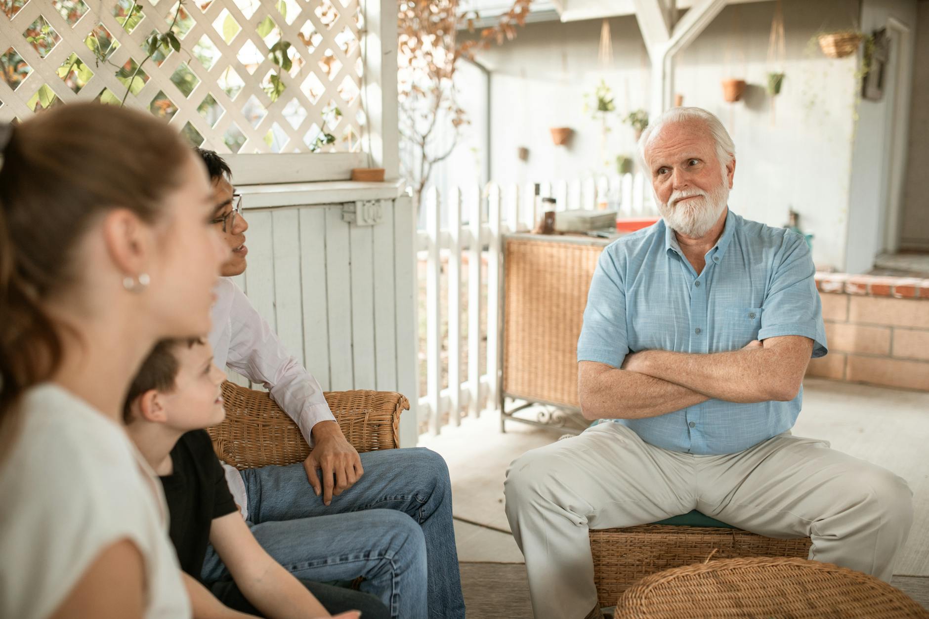 Family gathered indoors, engaged in conversation with a focus on bonds and togetherness. - family communication empathy