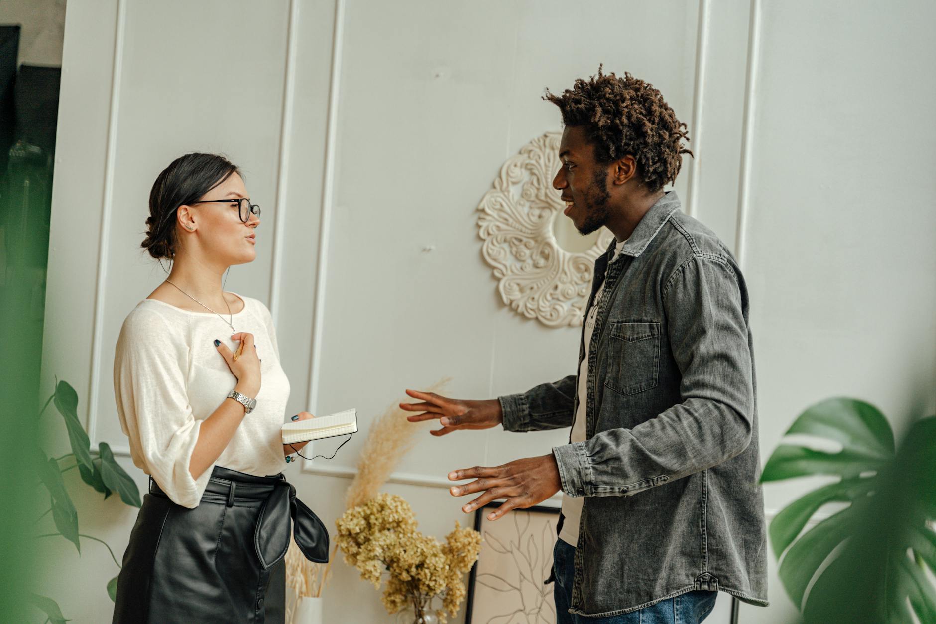 Two adults engaging in a friendly conversation indoors, sharing ideas. - improve relationship communication