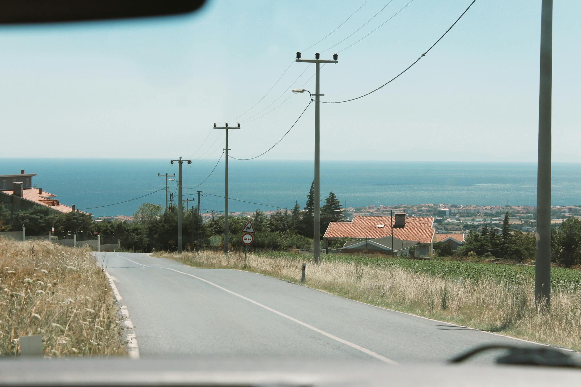 Tranquil drive along a coastal road with sea views and countryside scenery. - long distance summer