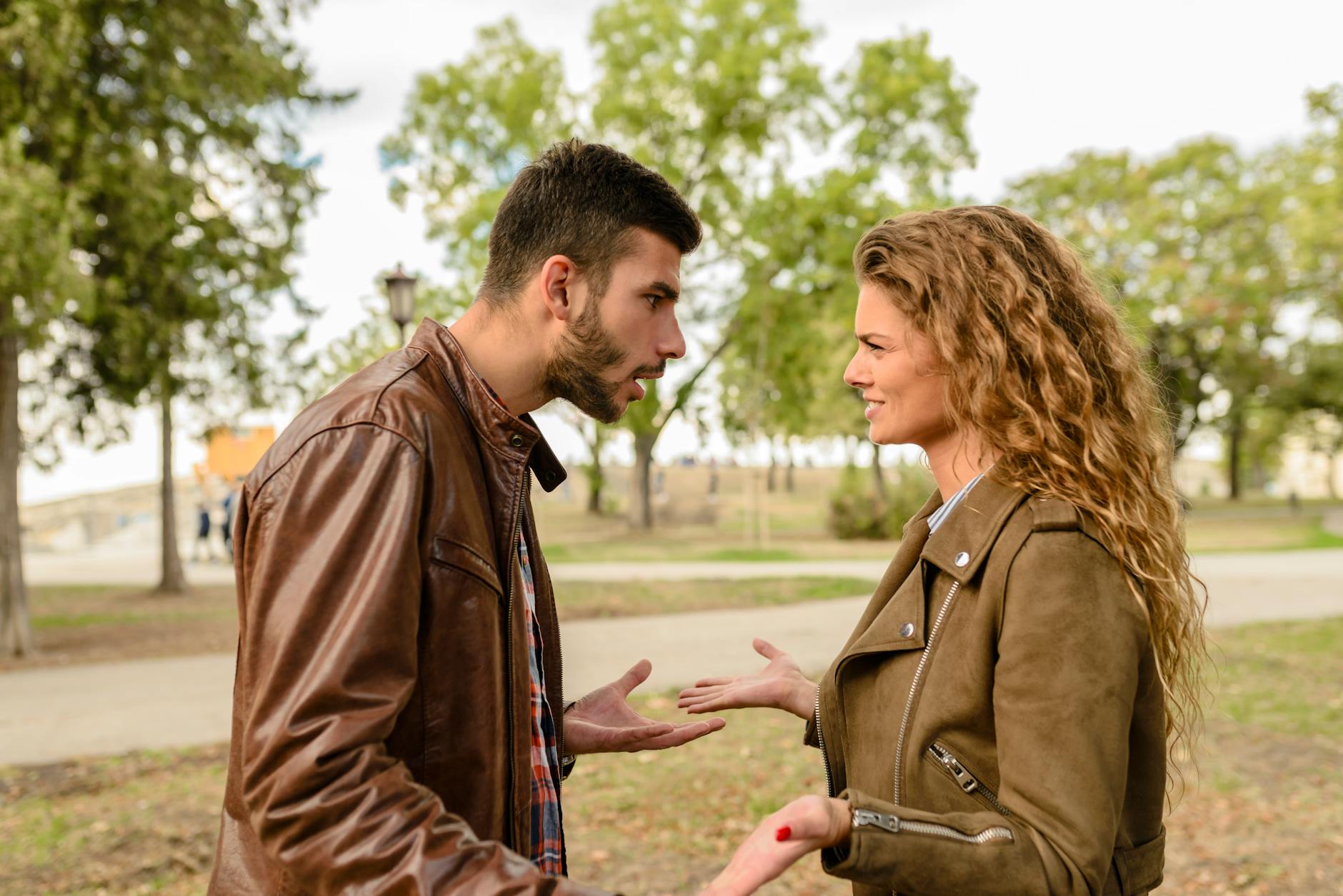 A couple having an argument outdoors, expressing frustration and conflict. - relationship conflict spring