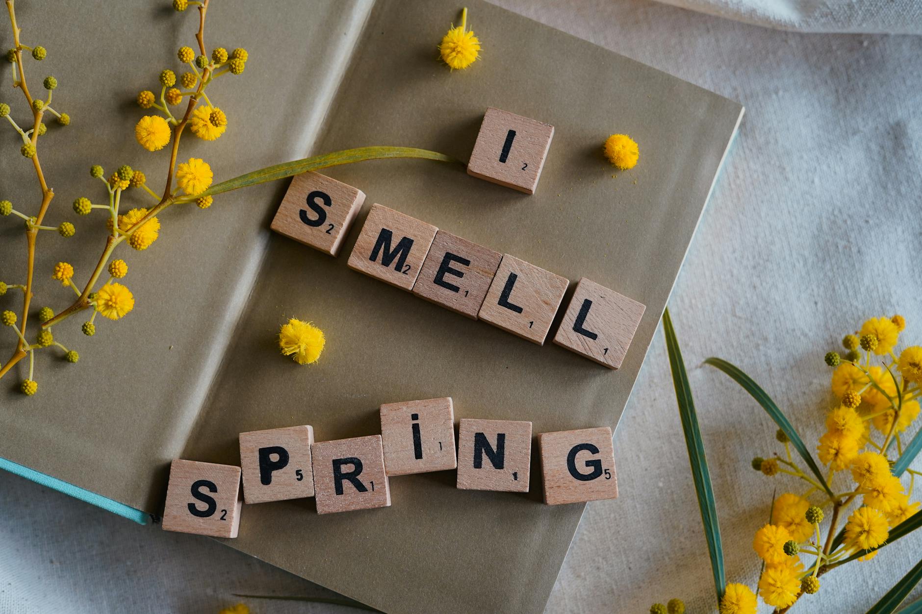A beautiful spring-themed composition with yellow flowers and scrabble tiles spelling 'I smell spring'. - spring stress management