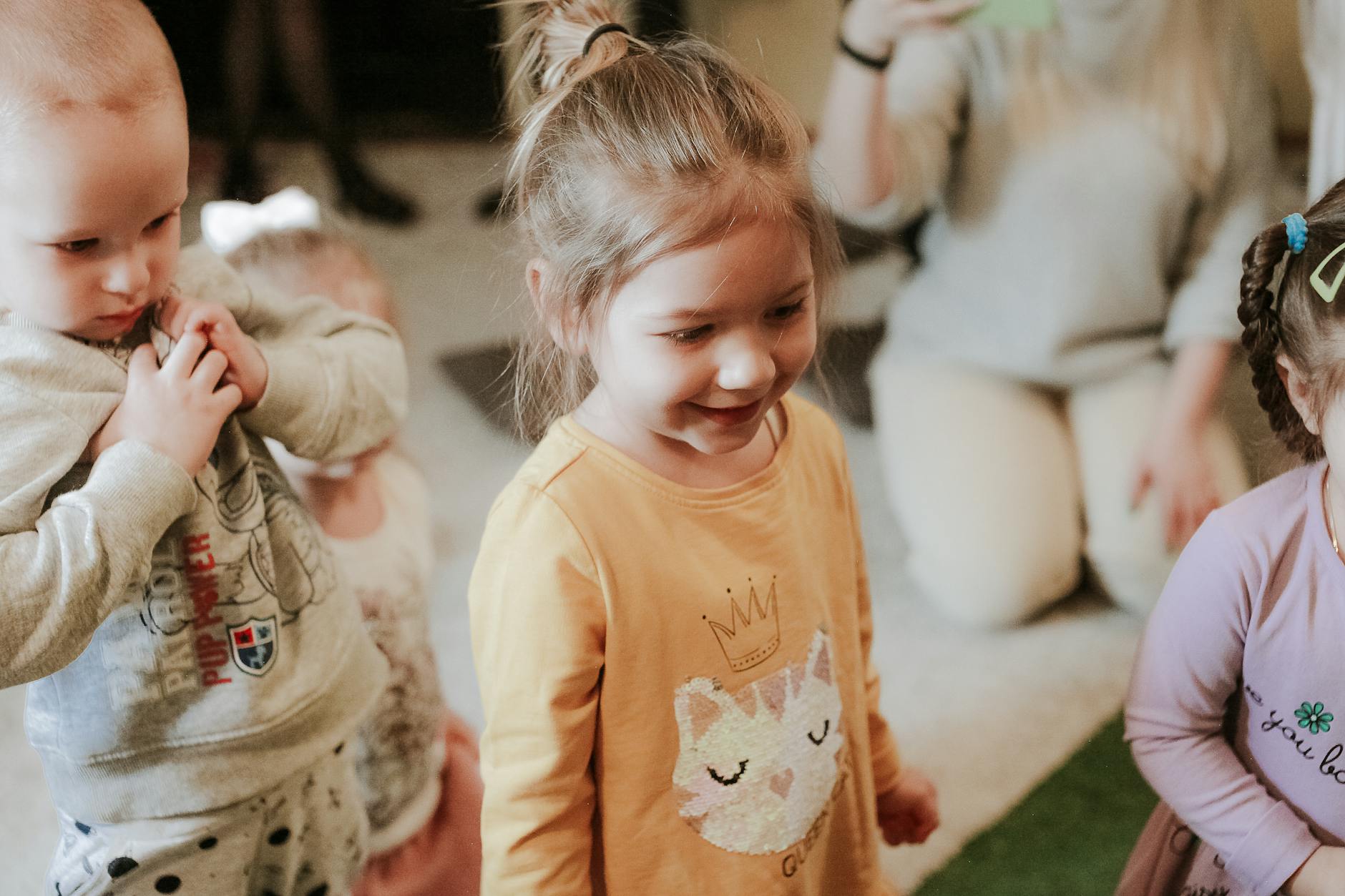 Happy children playing indoors with toys, showcasing joyful interaction and smiles. - toddler personal space